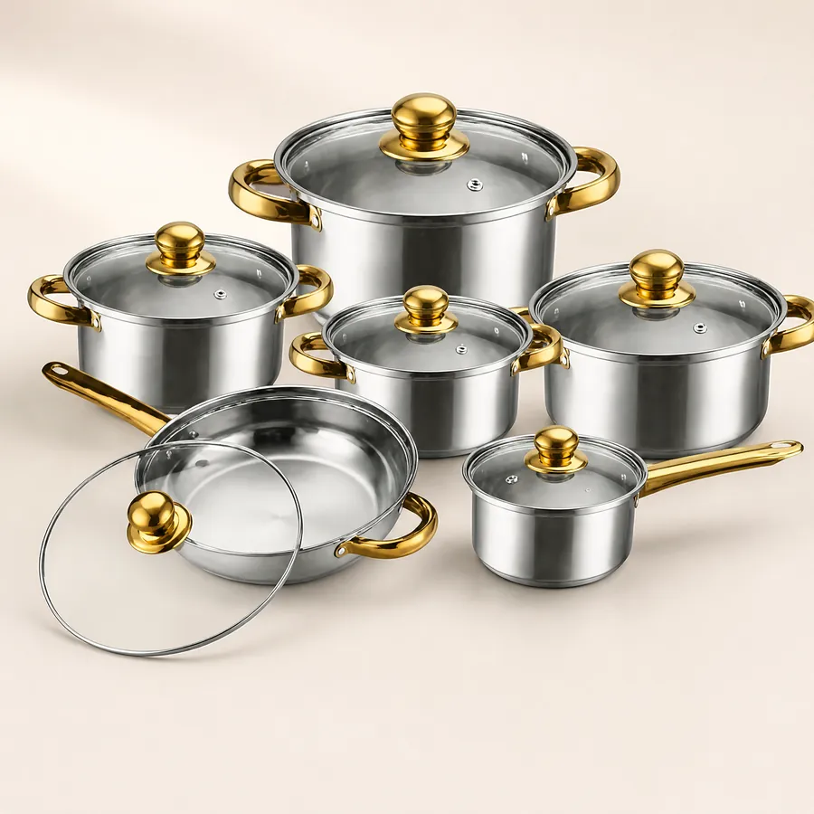 Six polished stainless steel pans with glass lids, gold-coloured knobs and handles